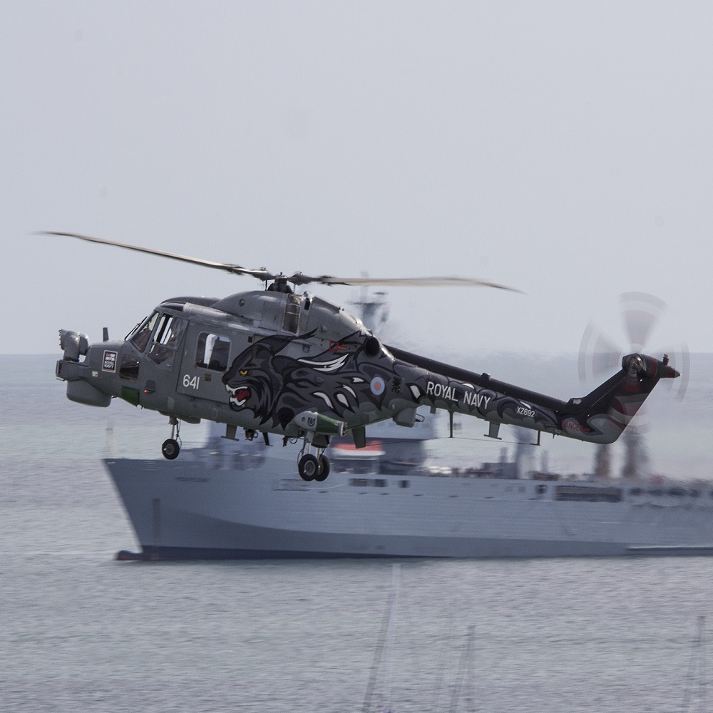 The Westland Lynx, British military helicopter with Royal Navy ship on the background